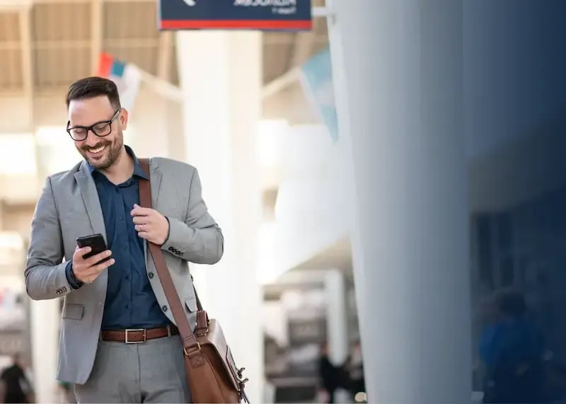Man in airport receiving a digital incentive.