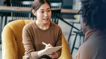 woman conducting interview with research participant