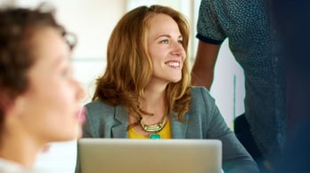 happy engaged employees at their desk in the office