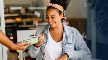 unclaimed gift card featured image woman using mobile phone to pay
