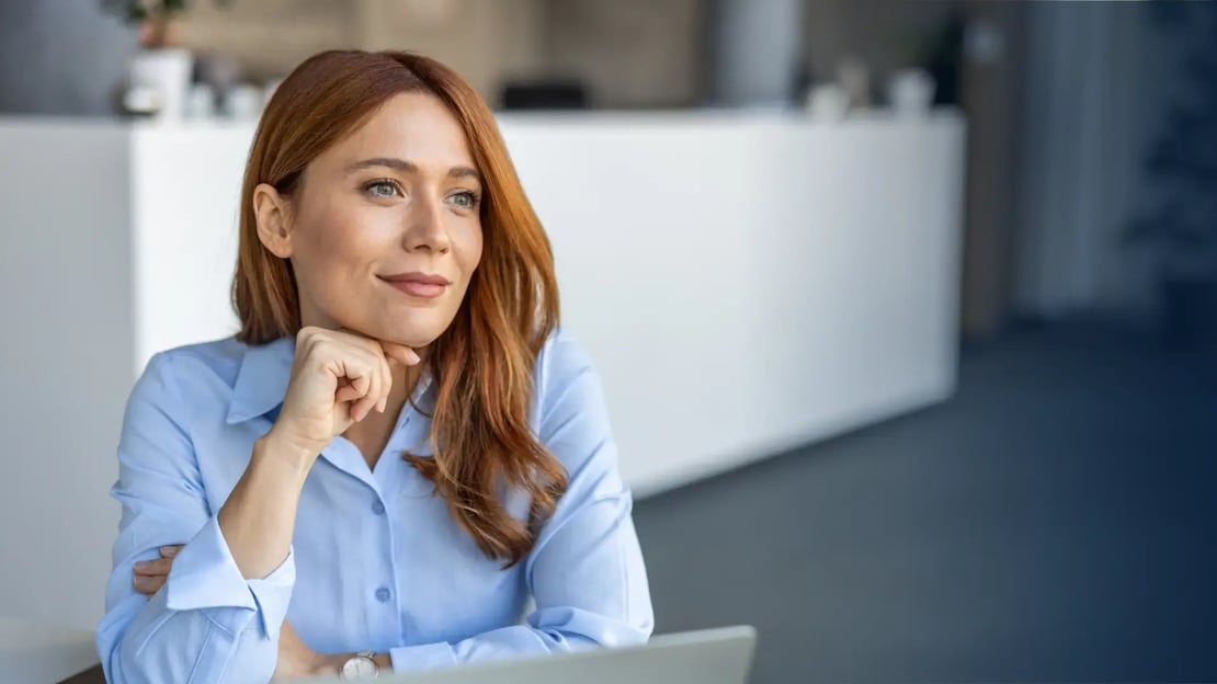 woman at desk - design a rewards program featured image