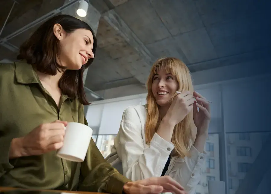 Two women in an office, using Giftbit on a laptop.